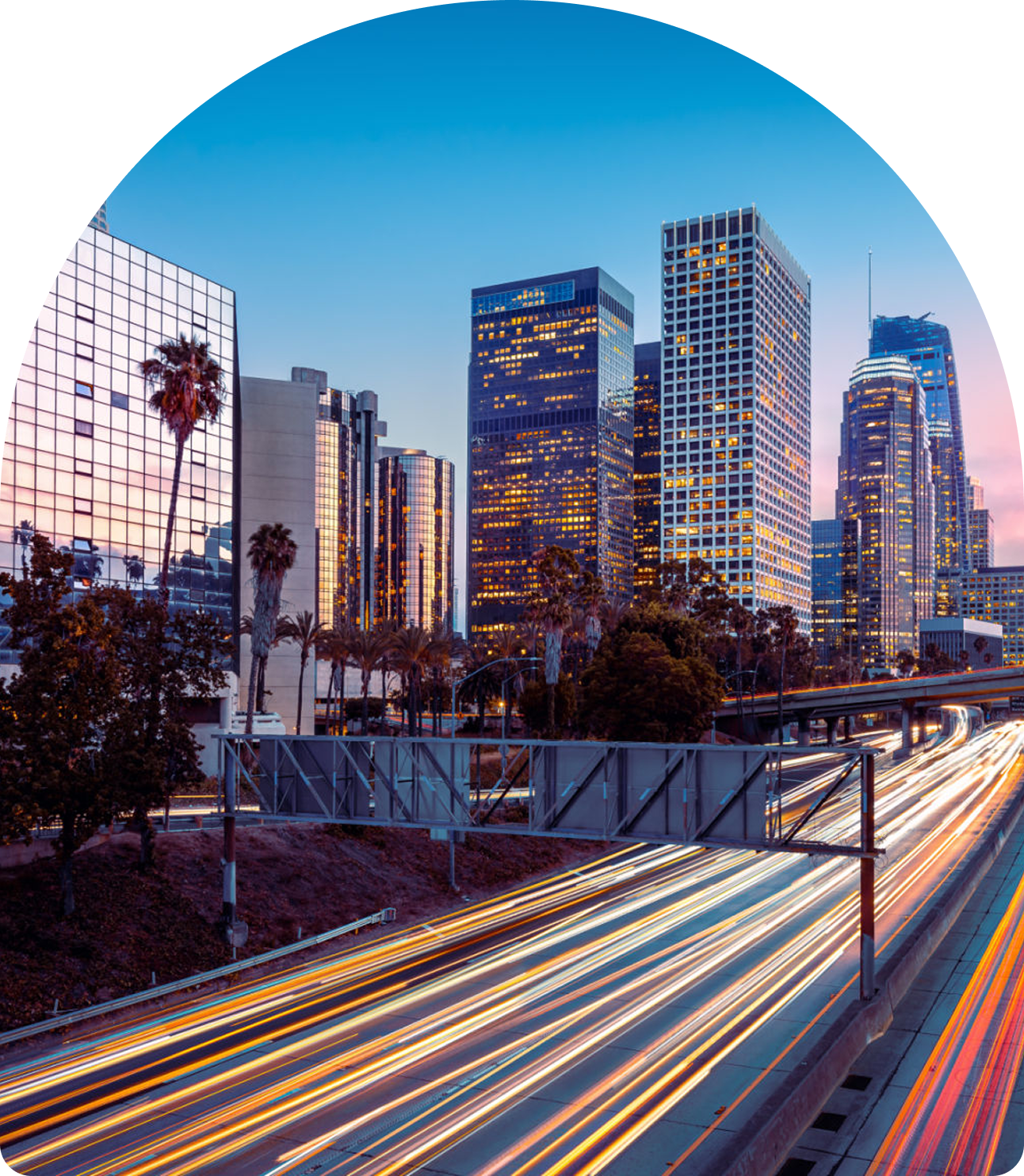 City skyline with light trails at dusk.