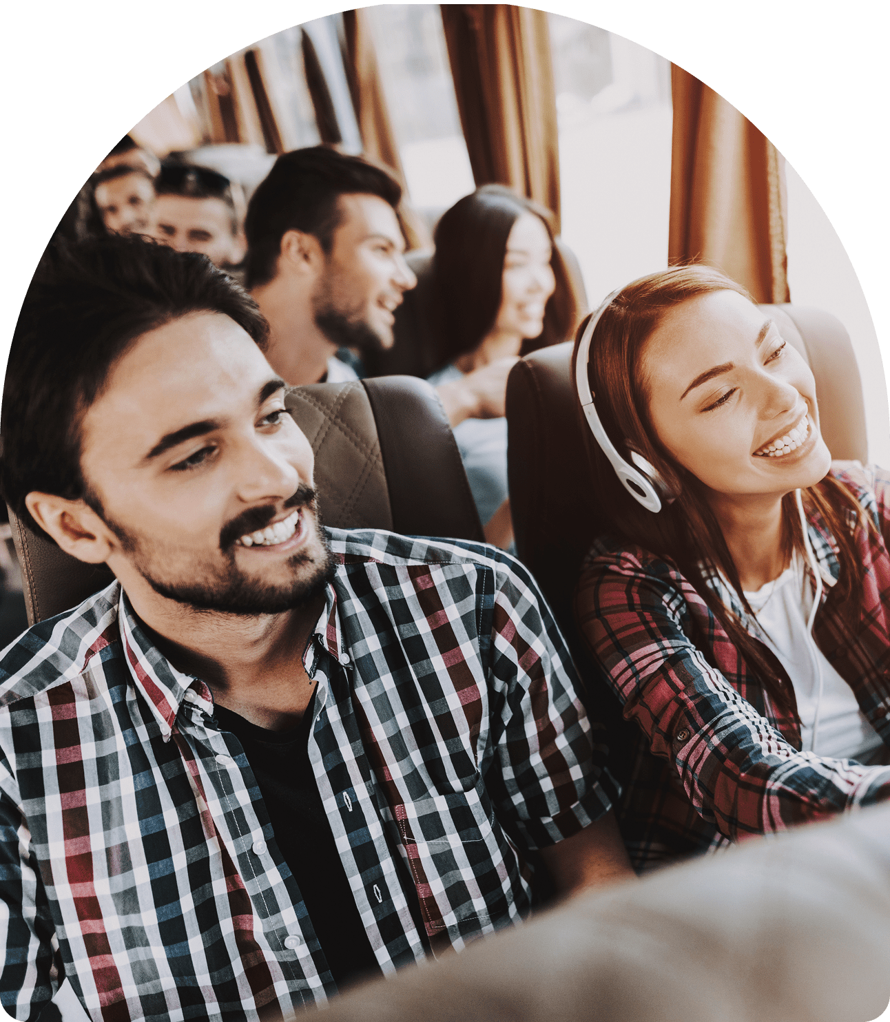 People enjoying a bus ride, smiling together.